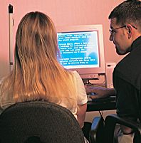 Image of JAWS trainer and student at workstation